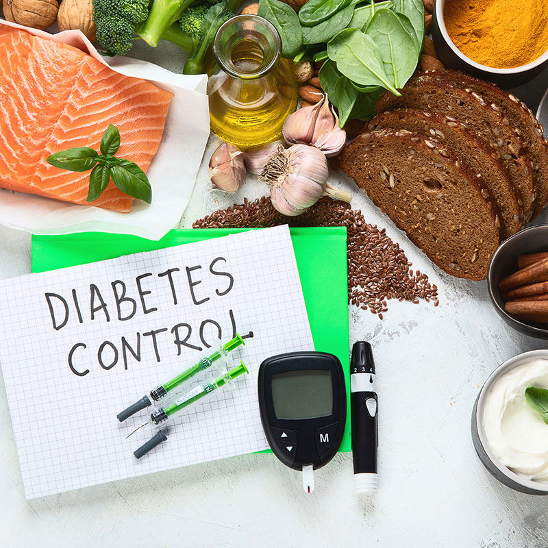 salmon garlic oil and vegetables on table with diabetic tester and insulin needles