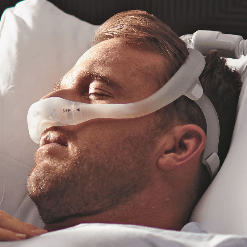 man sleeping in bed with dreamweaver sleep mask